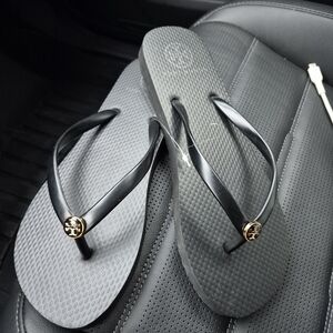 Tory Burch Black Flip Flops with Gold Logo Medallions